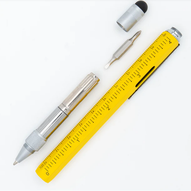 Yellow pen with a  ruler and small tools on a white background