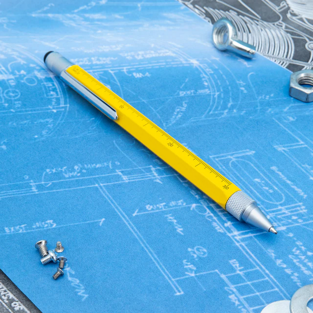 Yellow pen on a blueprint with screws and nuts