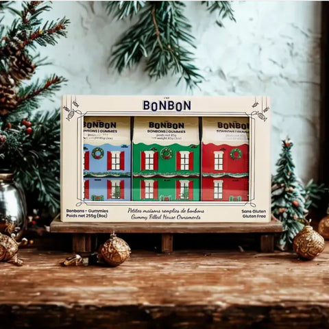 Box of Bonbon gummy filled house ornaments with Christmas decorations in the background Little House Ornaments - Gummy Candies La boîte à bonbons Gummy Candies art-noise.myshopify.com little-house-ornaments-gummy-candies
