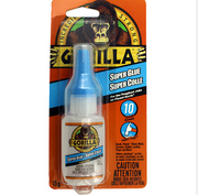Gorilla Super Glue bottle with packaging featuring a gorilla logo on an orange background.