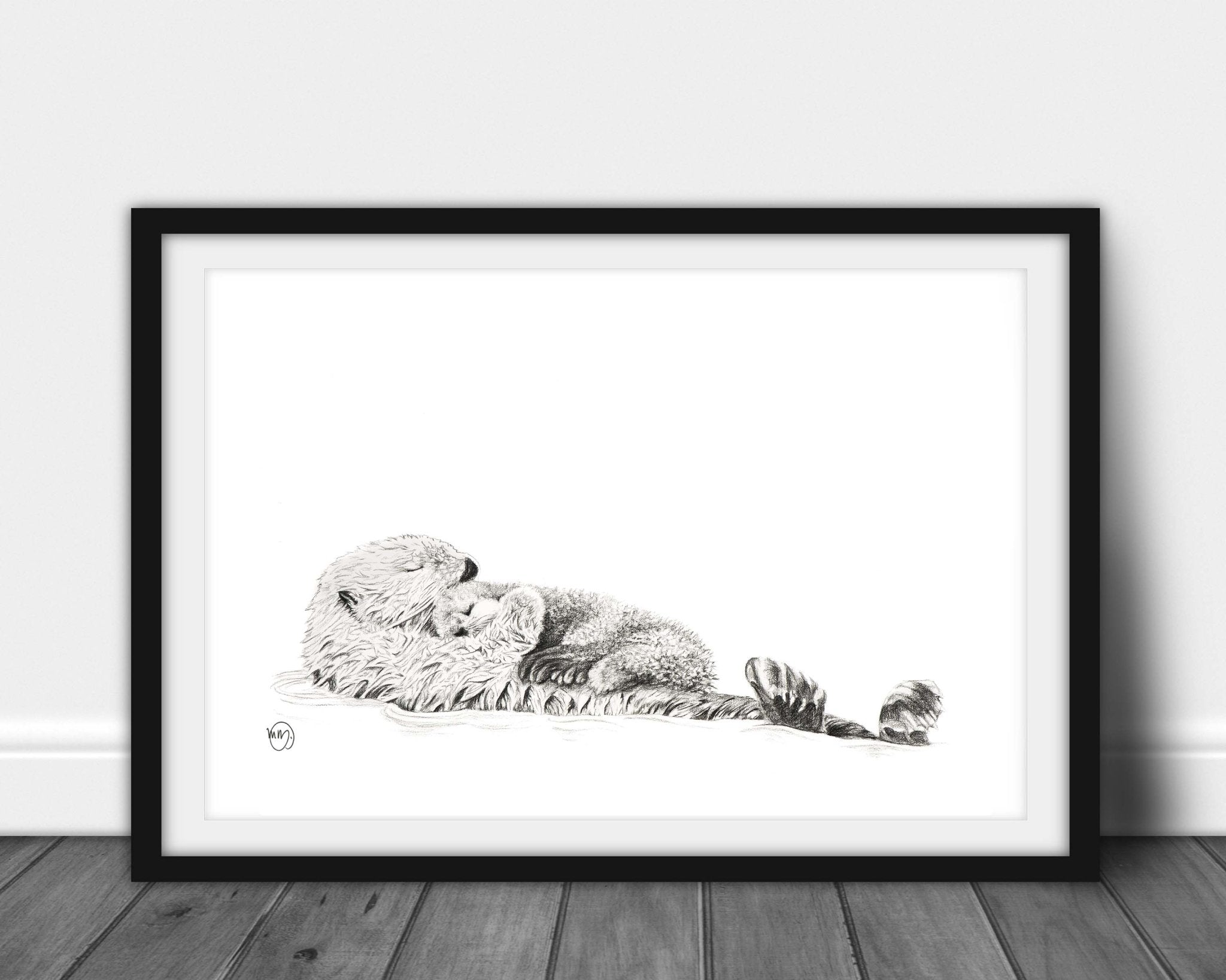 Adorable Sea Otter swimming with her Cub