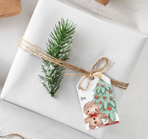 Gift wrapped in white paper with a decorative tag featuring a gingerbread man and Christmas tree design. Gingerbread Gift Tags Creativien product_type art-noise.myshopify.com gingerbread-gift-tags